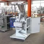 Designed to automatically package free-flowing tea or coffee. The machine features intermittent motion bag forming, complete with a volumetric feeder and hopper, variable speed control, solid-state temperature control, casters, and a safety switch. This machine uses all heat-sealable laminations, filter paper, etc.